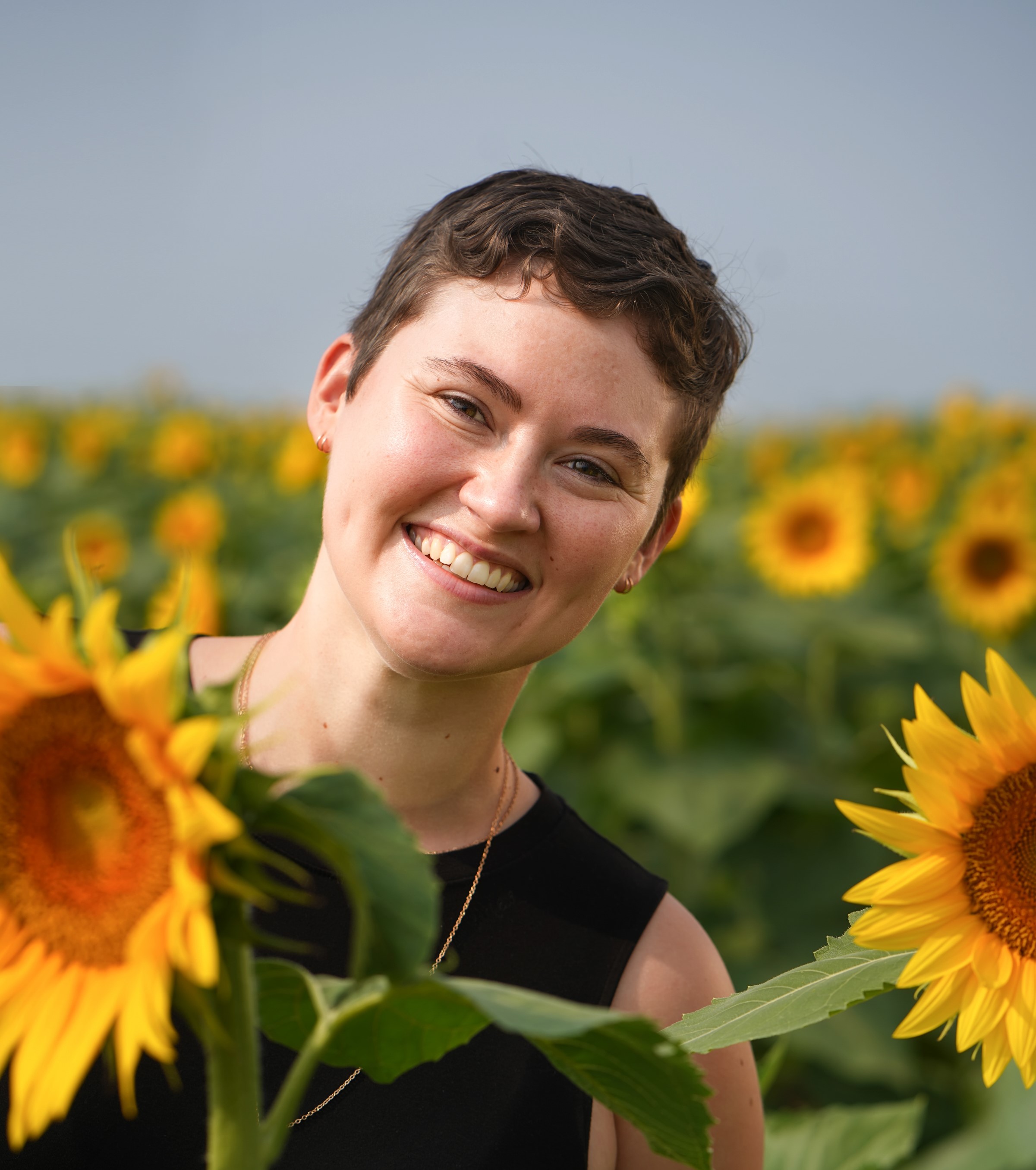 Pic of Sarah Kammeyer in a filed of sunflowers