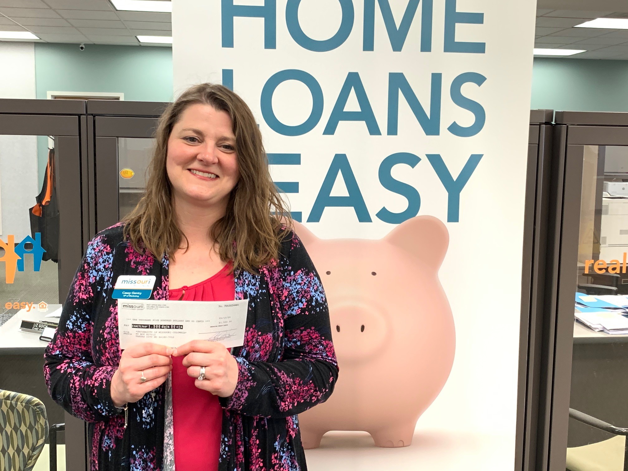 Missouri Credit Union's Casey L. Gentry with $1,500 check
